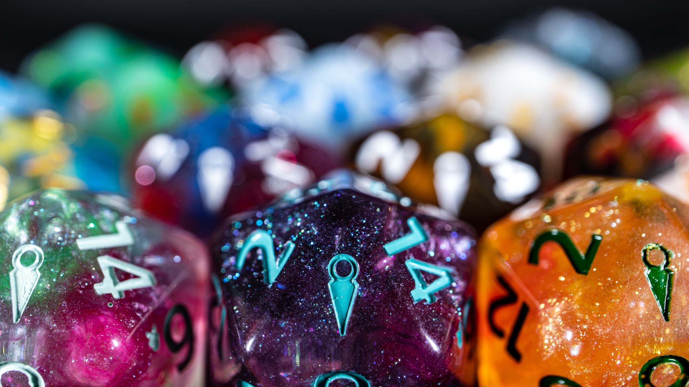 Close-up of the Mysterious Stranger D20 in front of the Town of Click Clack dice lineup